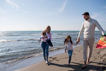 Eine Familie genißt die Zeit am Strand des Familienhotels strandkind an der Ostsee.