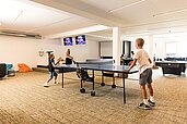 Spielzimmer für Kinder mit vielen Spielmöglichkeiten, wie Kicker, Airhockey und einer Bowlingbahn im Almfamilyhotel Scherer in Obertilliach in Tirol.