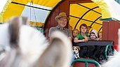 Kinder bei einer Kutschfahrt mit dem Planwagen im Rahmen der Kinderbetreuung des Familienhotels Landhuus Laurenz.