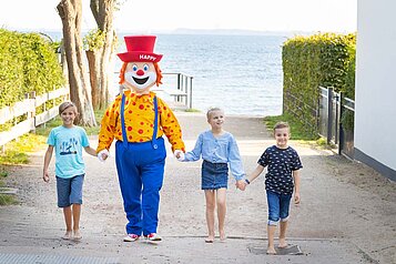 Kinder beim Strandausflug mit Maskottchen Happy im Familienhotel Strandkind an der Ostsee