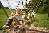 Kinder spielen auf dem Außenspielplatz des Schreinerhofs.