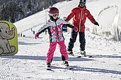 Kinder lernen im Familienhotel Galtenberg in Tirol das Skifahren.