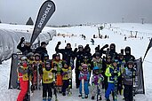 Die Kinder der Kinderskischule stehen auf der Piste und posieren für die Kamera im Familienhotel Feldberger Hof im Hochschwarzwald.