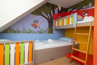 Ein buntes Kinderzimmer mit zwei Kinderbetten im Familienhotel Kolping in Ungarn