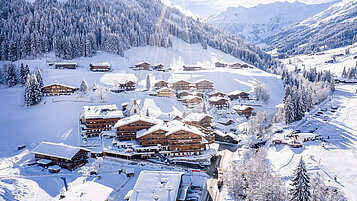 Außenansicht im Winter des Familienhotels Galtenberg Family & Wellness Resort. Das Familienhotel ist eingebettet in eine winterliche Landschaft und liegt in unmittelbarer Nähe zur Skipiste. 