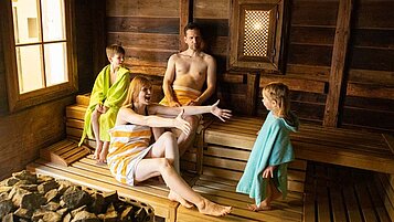 Eine Familie entspannt im in der Sauna des Familienwellness im Familienhotel Seeklause.