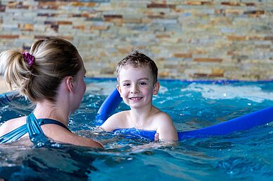 Kleiner Junge lernt im Elldus Resort im Erzgebirge das Schwimmen.