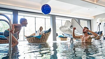 Die ganze Familie im Indoor-Schwimmbad im Familienhotel Amiamo im Salzburger Land.