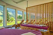 Ruhebereich mit Liegen und Panoramafenstern im Wellnessabteil des Familienhotels Kirchheimerhof in Kärnten.