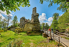 Wandern im Fichtelgebirge durch den Wald an alten Ruinen vorbei.