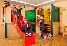 Spielende Kinder im Spielbereich im Familienhotel Sonne Bezau Vorarlberg.