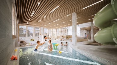 Kinder spielen und planschen im Indoor-Wasserbereich mit Rutsche im Familienhotel Gorfion.